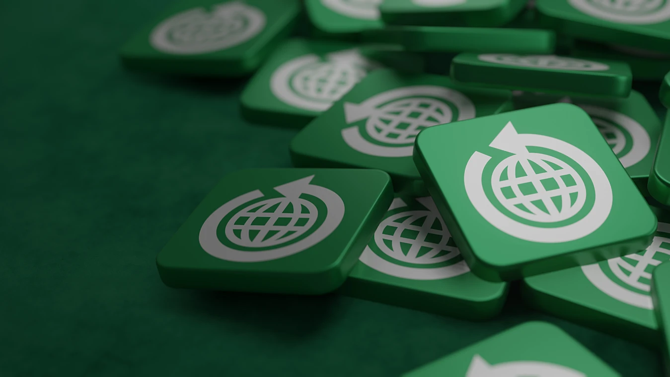 Green square tiles with a white globe and arrow symbol scattered on a green surface.